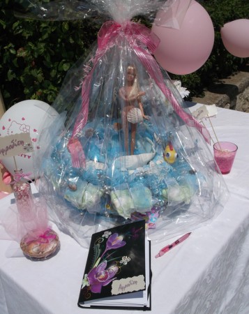 Το τραπέζι της υποδοχής, με το ιδιαίτερο βιβλίο για τις ευχές των καλεσμένων, την ... βαφτιζόμενη Αφροδίτη, τα καρτελάκια με το όνομα σε βαζάκι και ποτηράκι, καθώς κι ένα καλαθάκι με κοχύλια σε ροζ τούλι! 